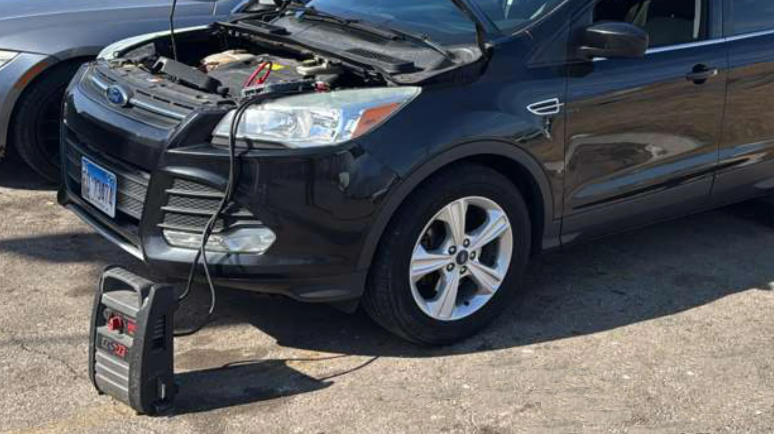 Vehicle receiving a jump start with jumper cables connected